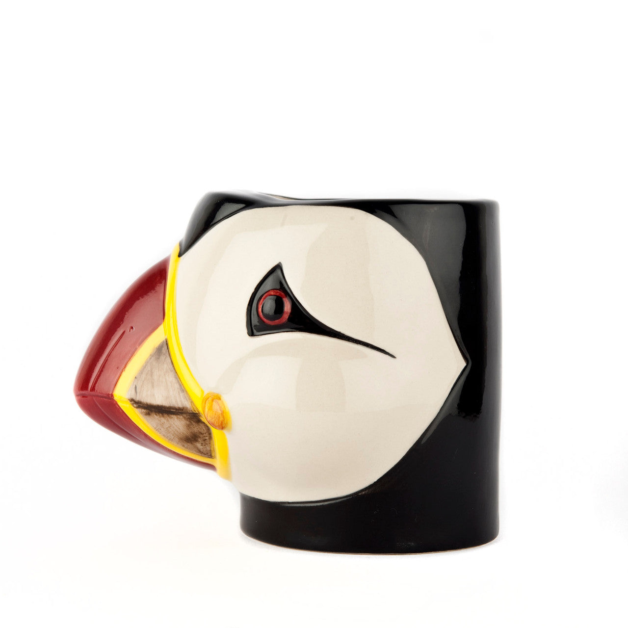 Ceramic puffin mug; off-white face, black and red beak, yellow accents.