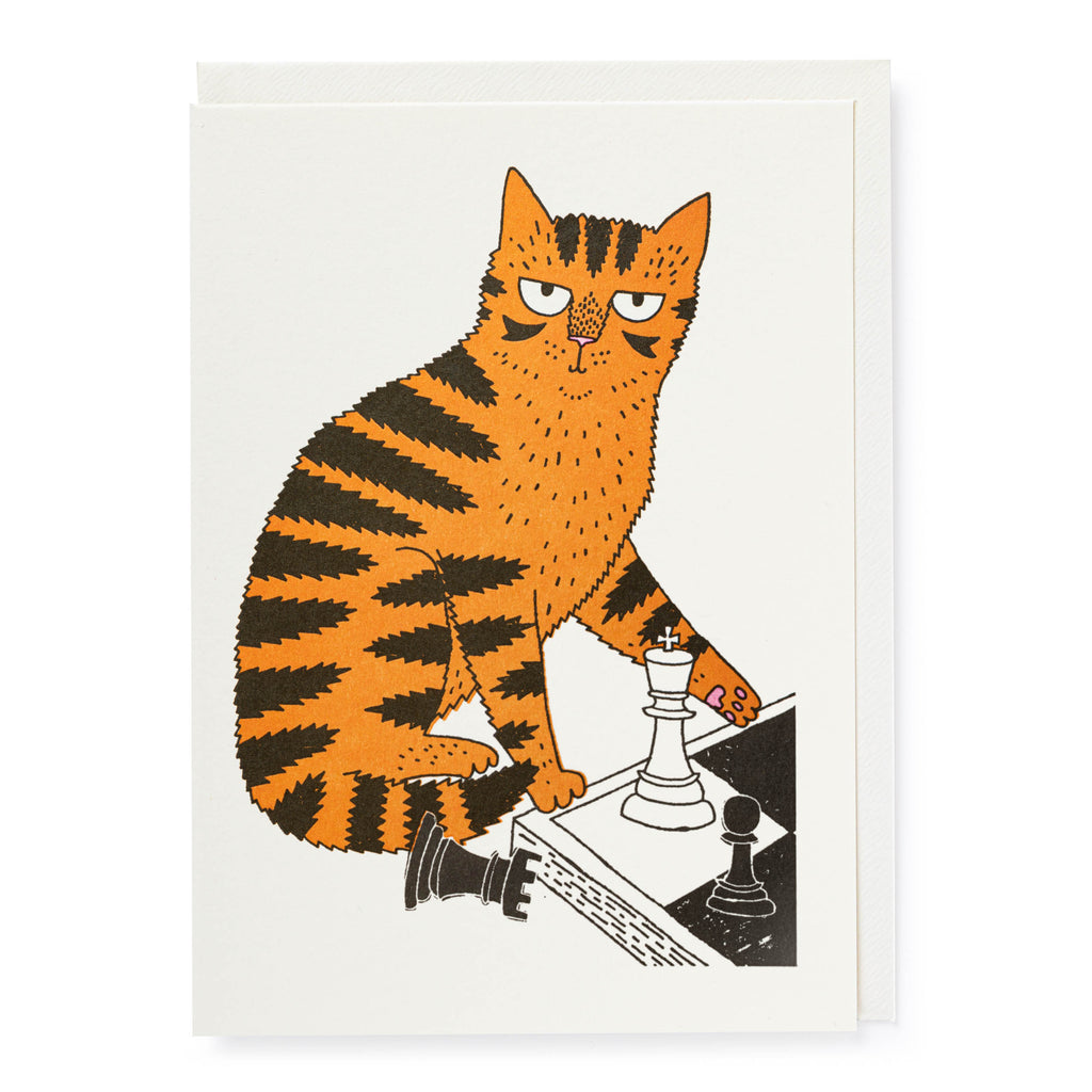 Greeting card illustration of an orange tabby cat playing chess, knocking over a black rook with its paw.