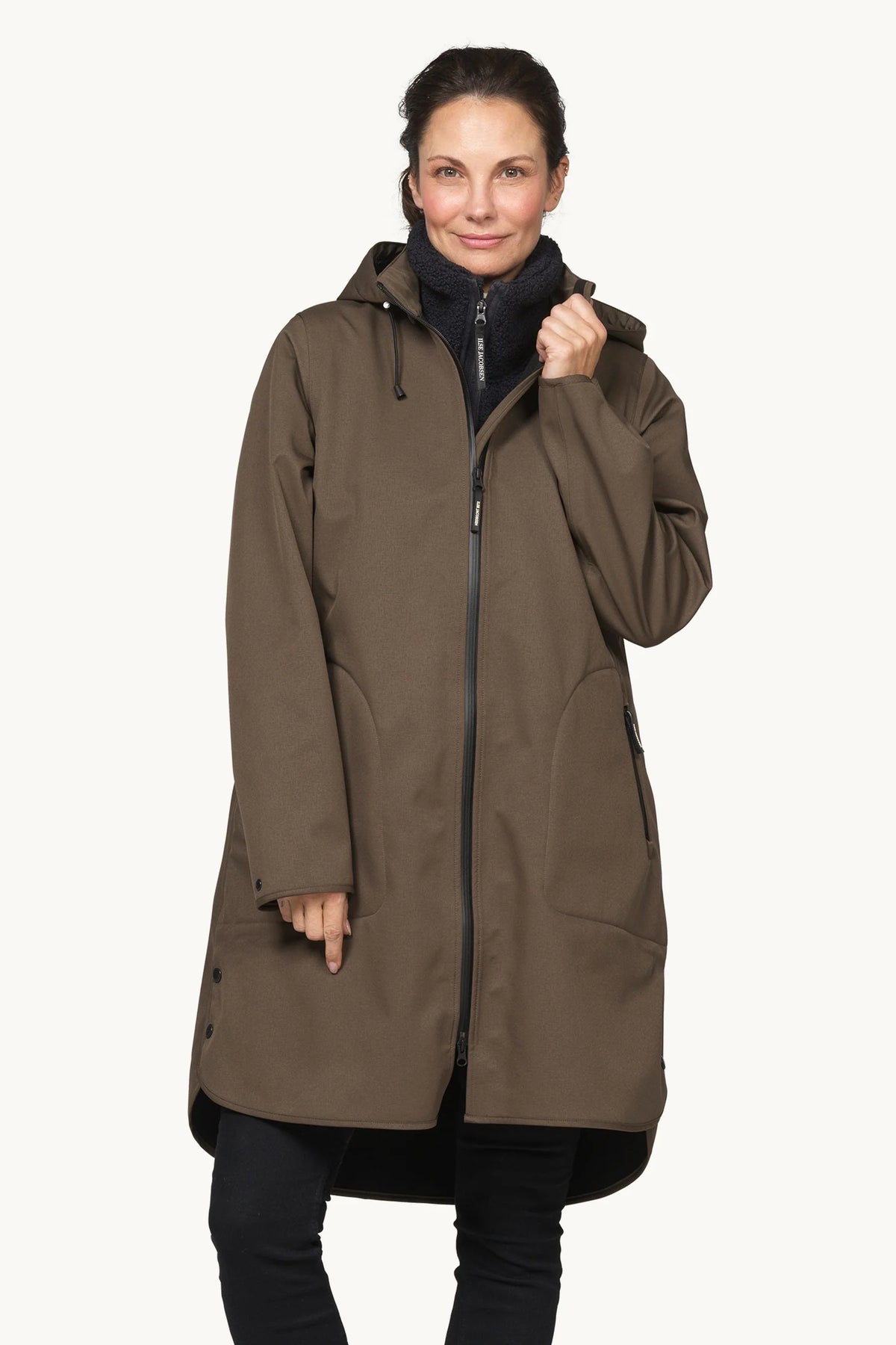 A woman modeling a mid-length brown hooded jacket with a front zipper, shown against a plain light background.