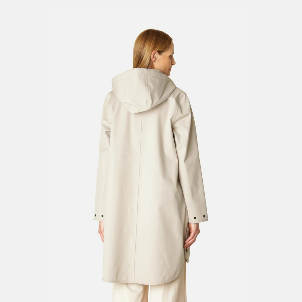 Beige hooded raincoat, rear view, showing smooth matte texture and simple design. Long sleeves, buttoned cuffs.