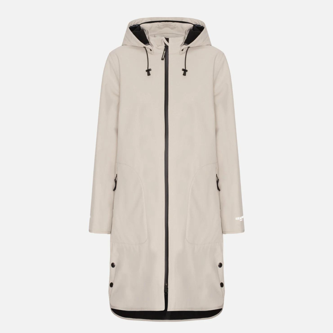 Beige hooded raincoat with zipper closure, welt pockets, and snap buttons at the hem. Features a minimalist design and subtle