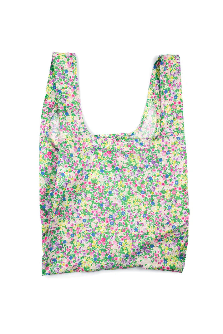 Reusable shopping bag with a small-scale floral print in shades of pink, purple, green, and yellow on a cream background.