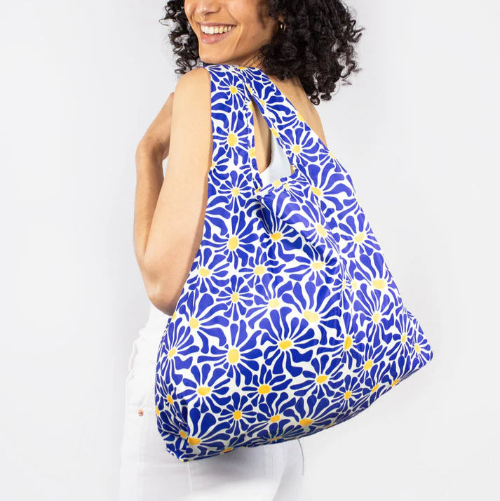 Reusable shopping bag with a blue and yellow floral pattern.