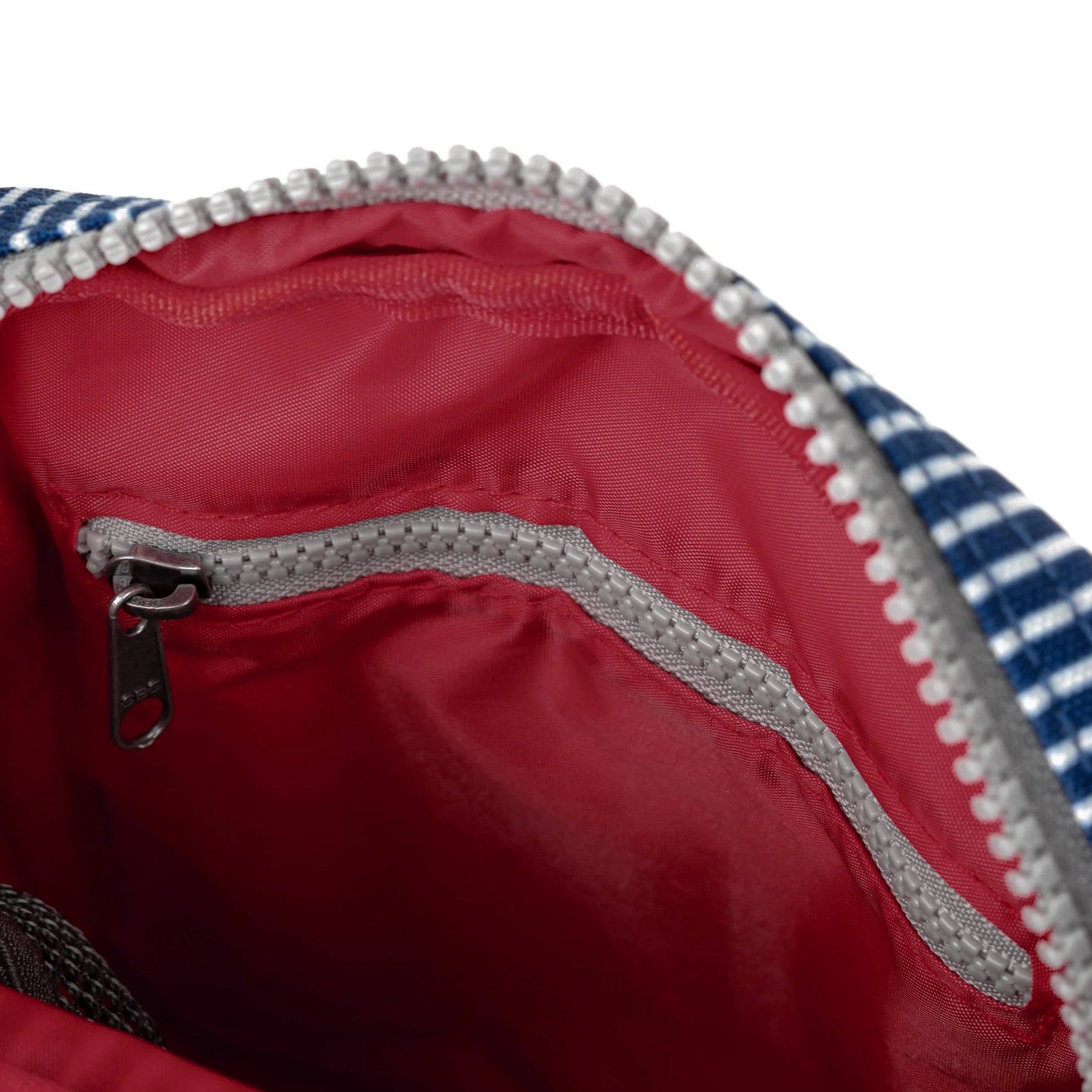 Close-up of a red bag with a zipper and blue and white checkered pattern on a white background