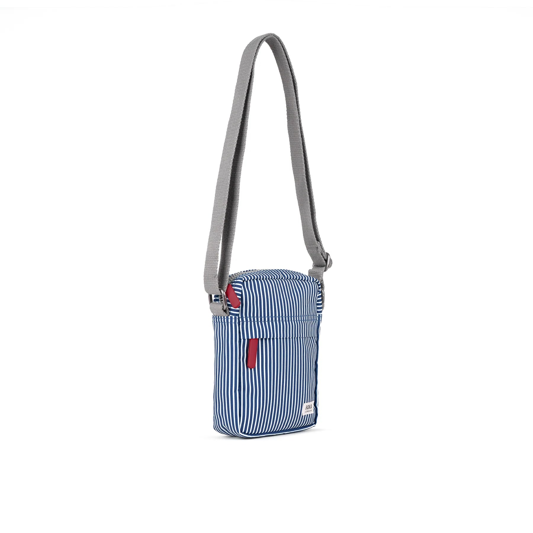 Blue striped crossbody bag with a red tag on a white background