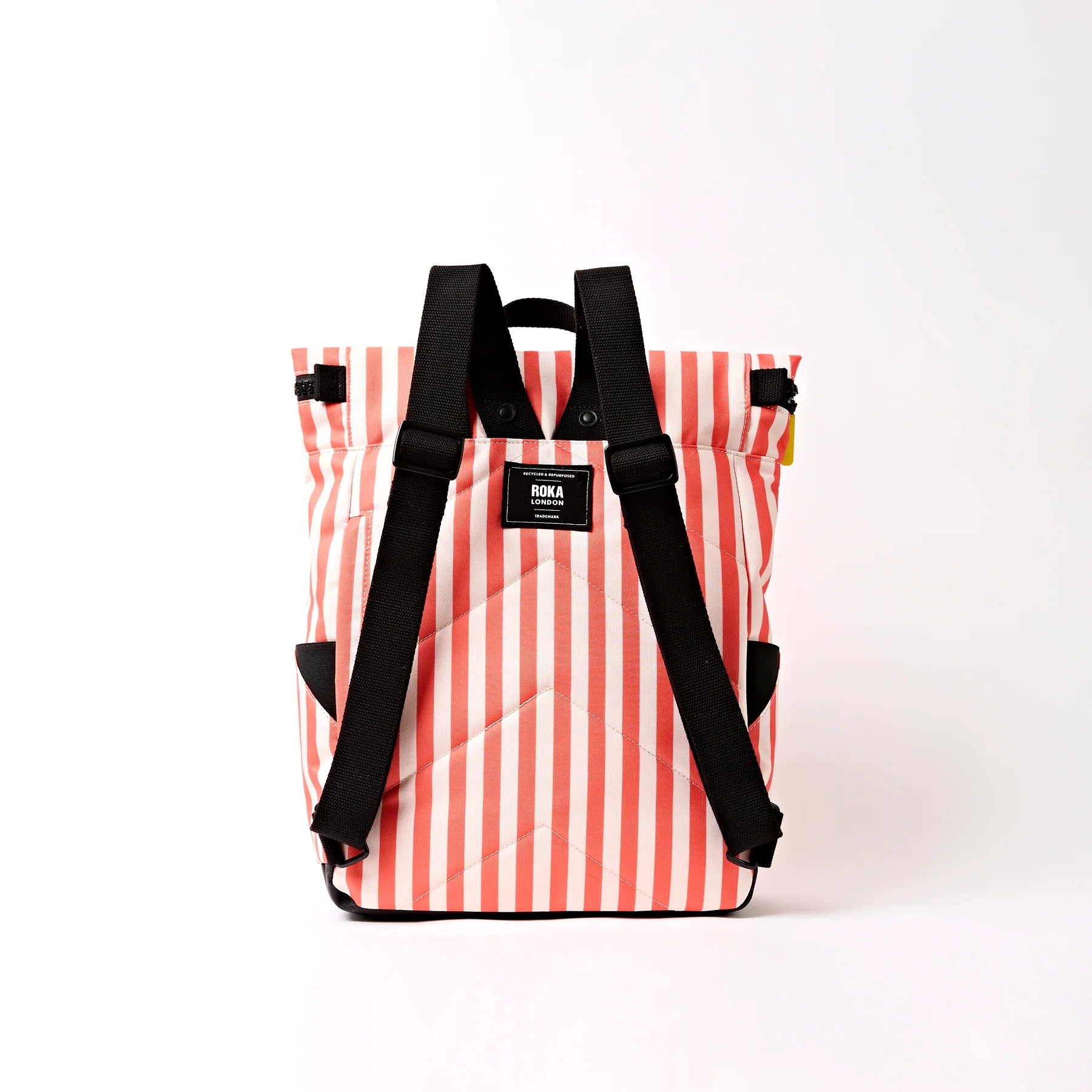 Striped backpack with black straps on a white background