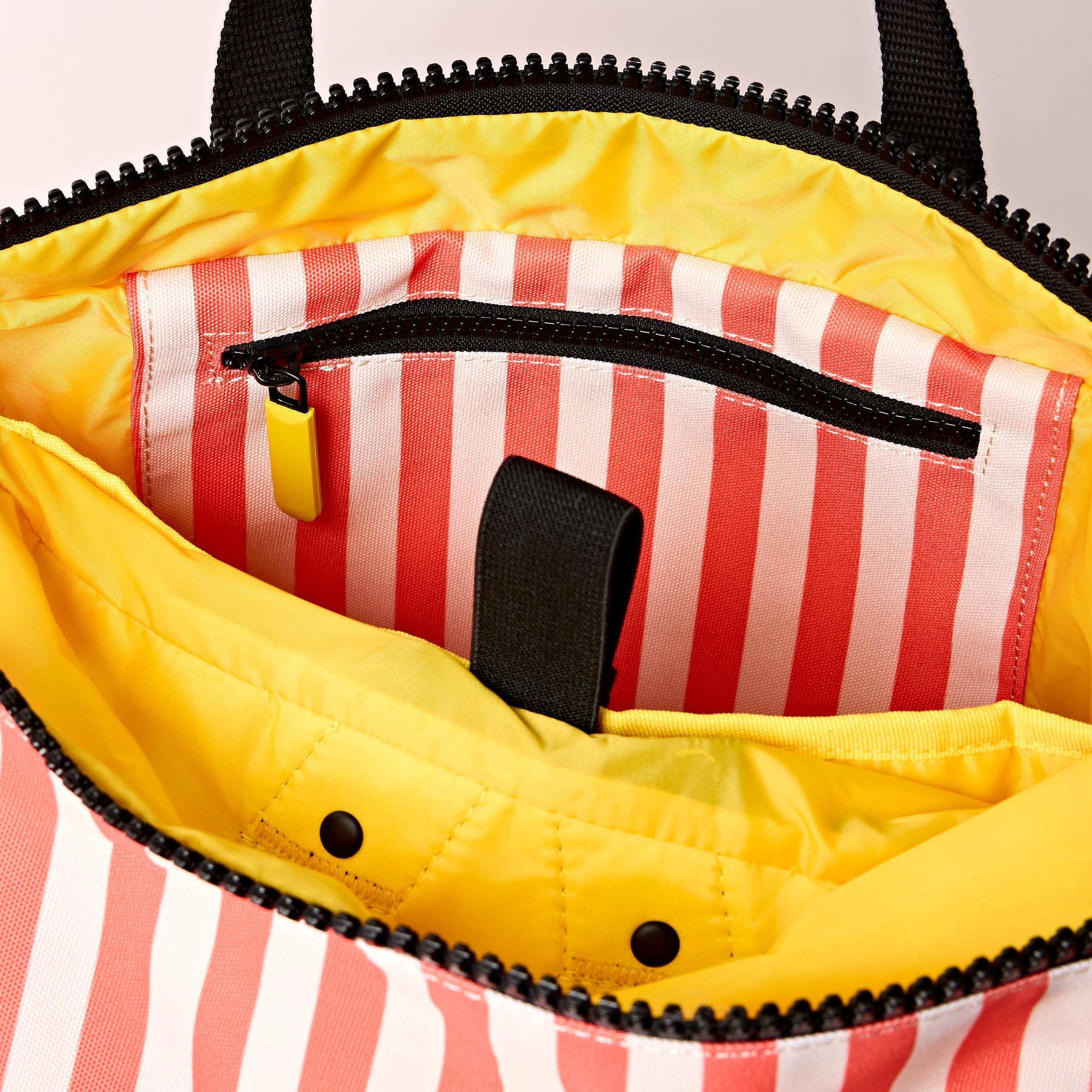 Yellow bag with red and white striped lining