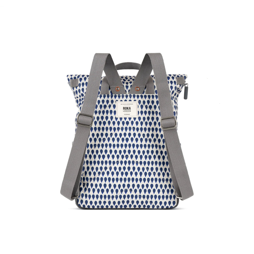ROKA London backpack featuring a stylish blue and white raindrop pattern with durable gray straps.