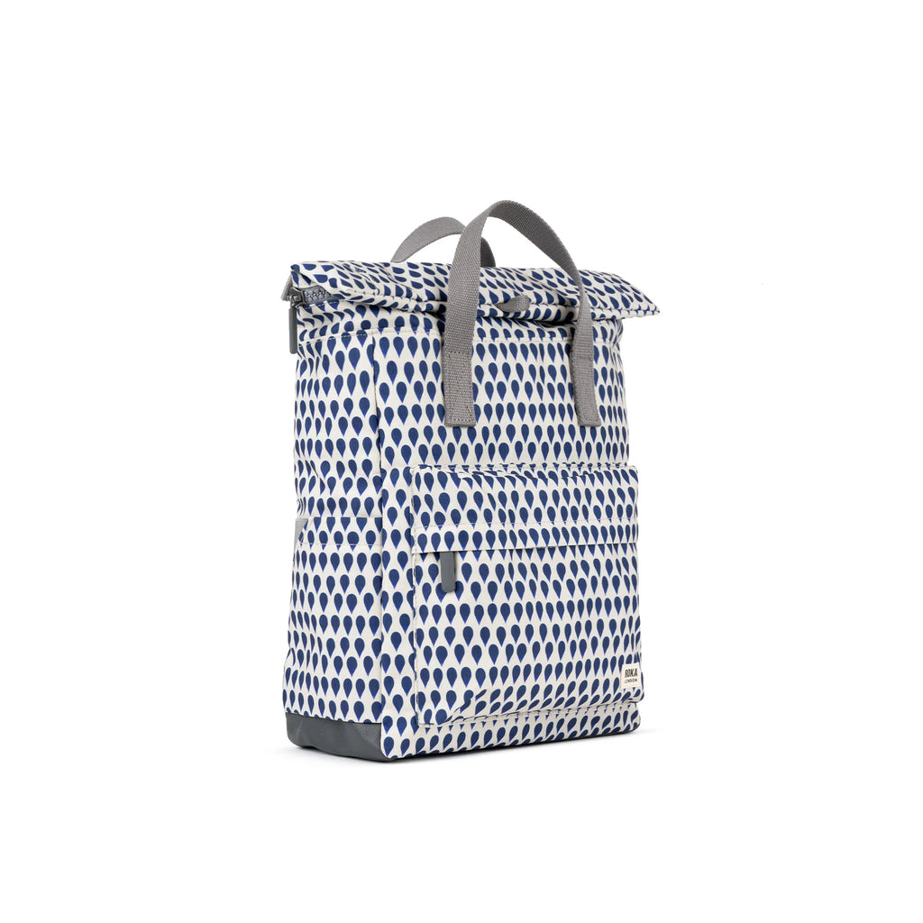 ROKA patterned backpack with gray handles and front pocket, featuring a blue and white drop design.