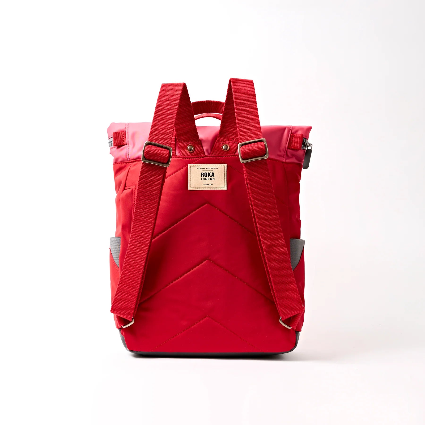 Red backpack with a visible brand label on a white background