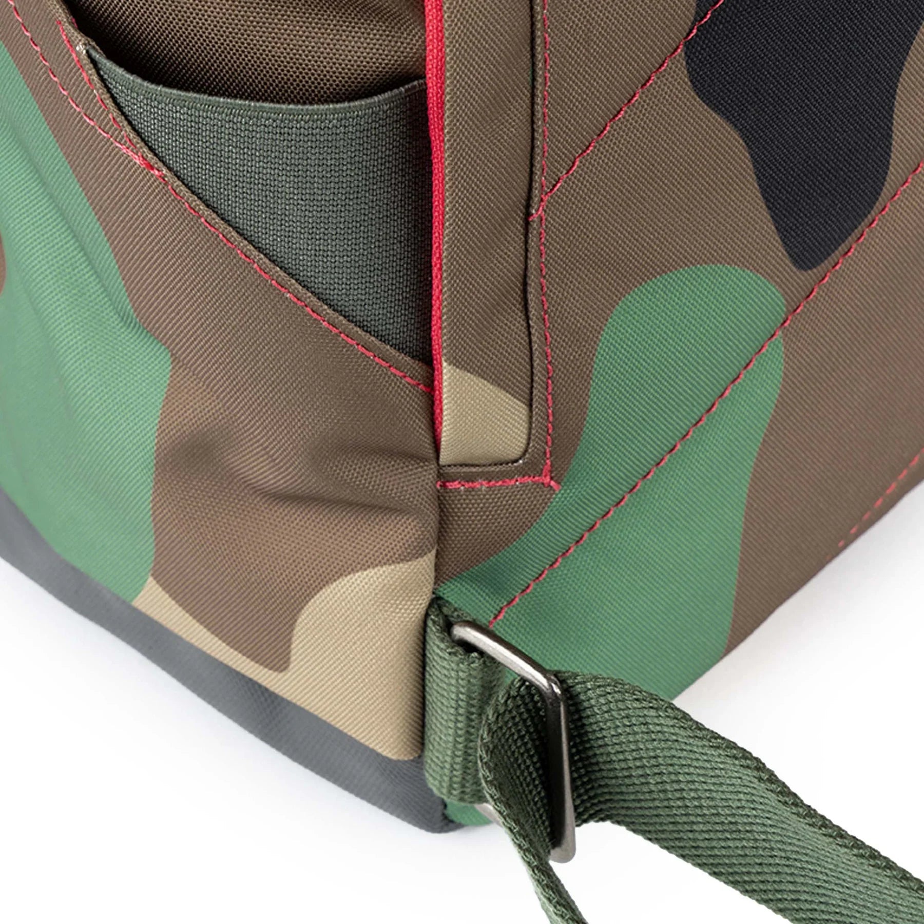 Close-up of a camouflage bag with a strap on a white background