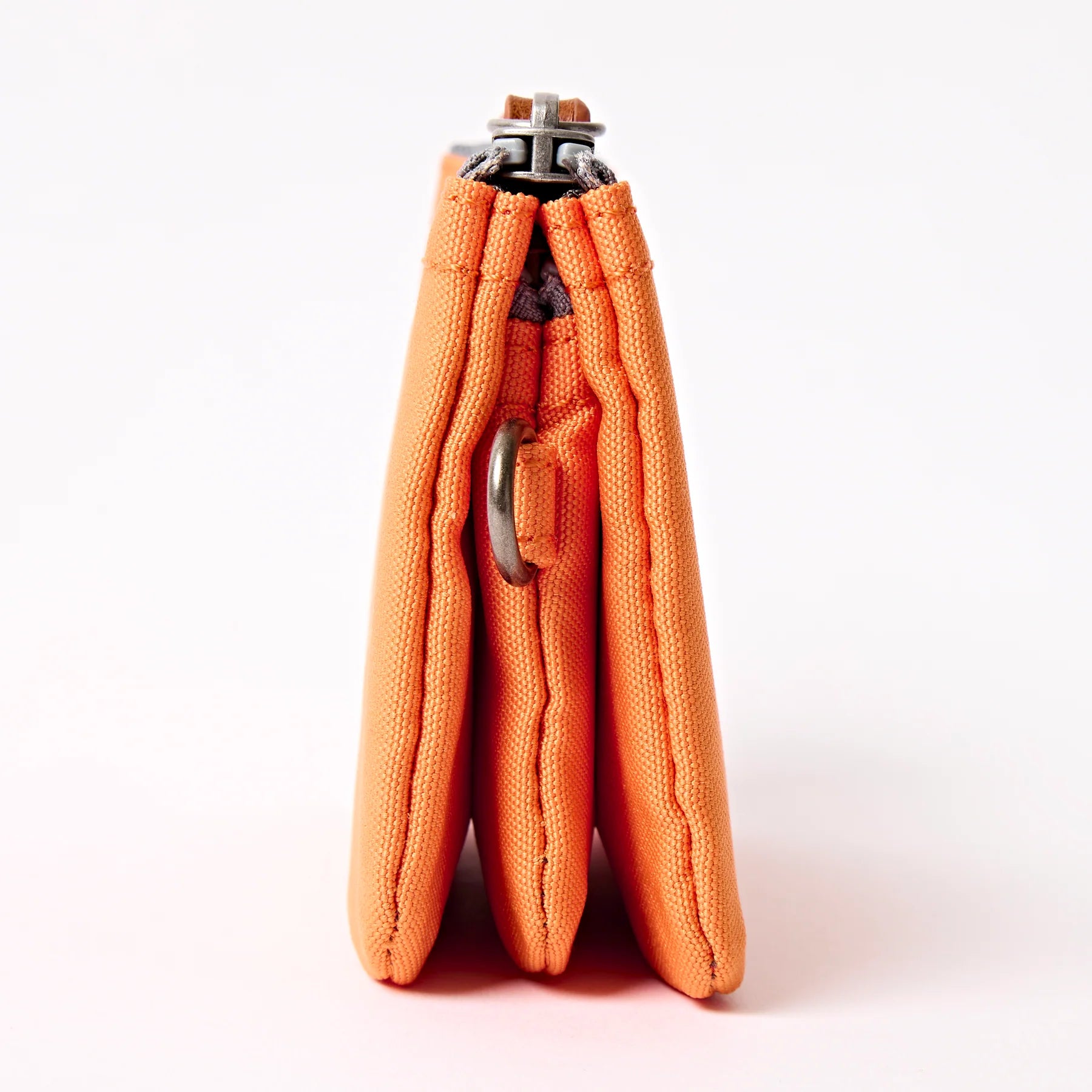 Orange fabric product with metal clip on a white background