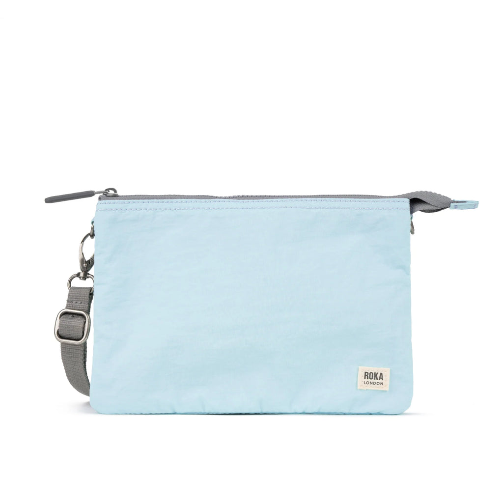 Light blue ROKA pouch with a gray strap and zipper, featuring a small brand tag on the bottom right.