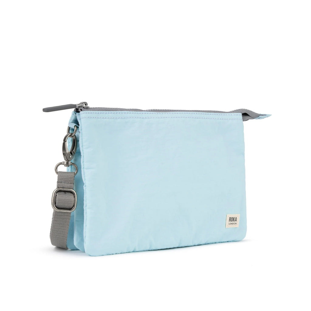 Light blue ROKA pouch with a gray strap and zippered closure, stylish and compact for everyday use.