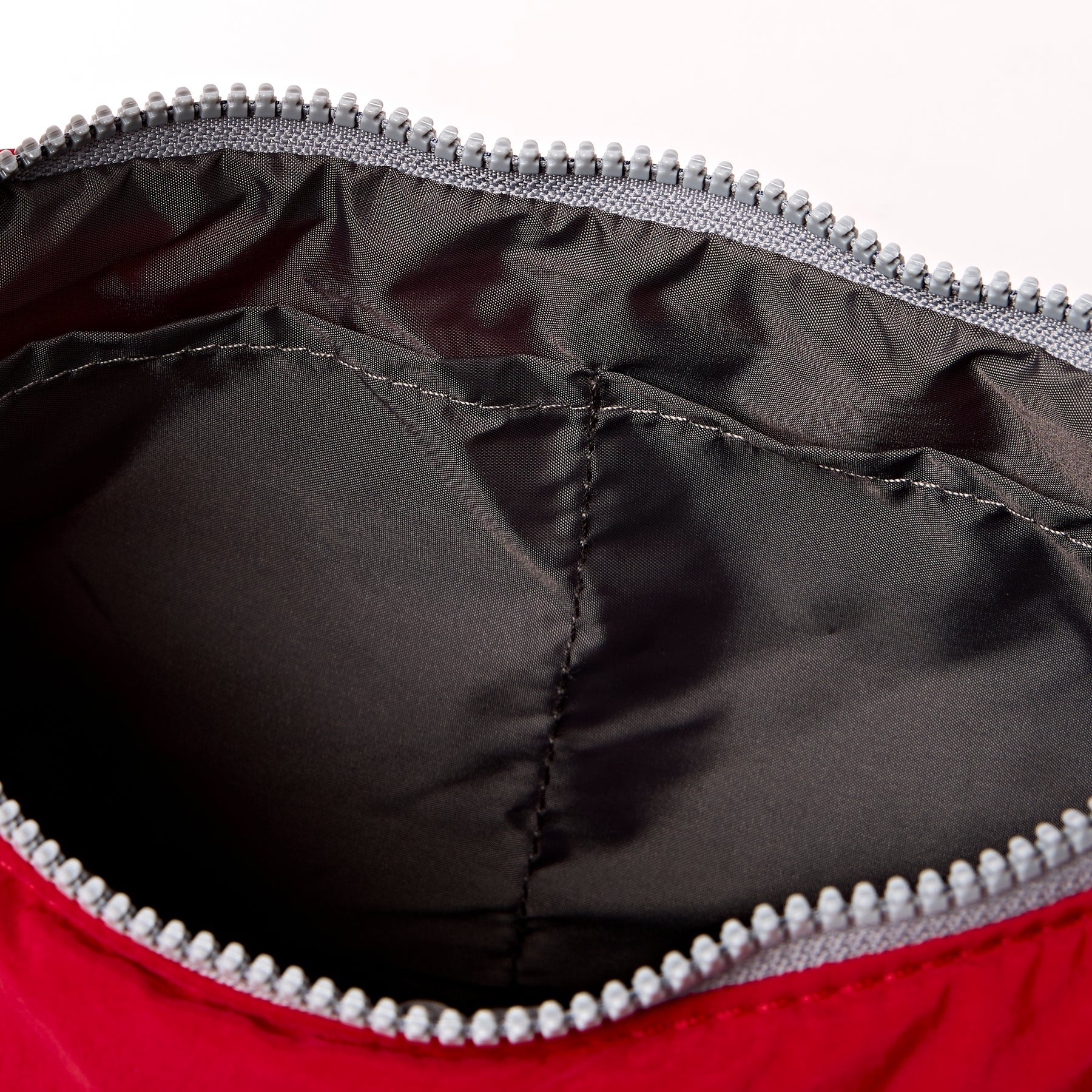 Close-up of a red and black jacket with a zipper