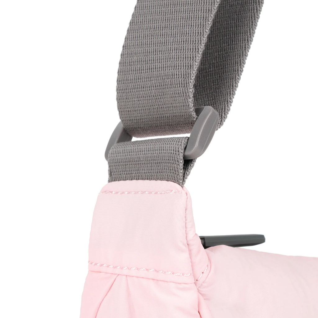 Close-up of a ROKA bag's pink fabric and gray strap with a sturdy buckle detail.