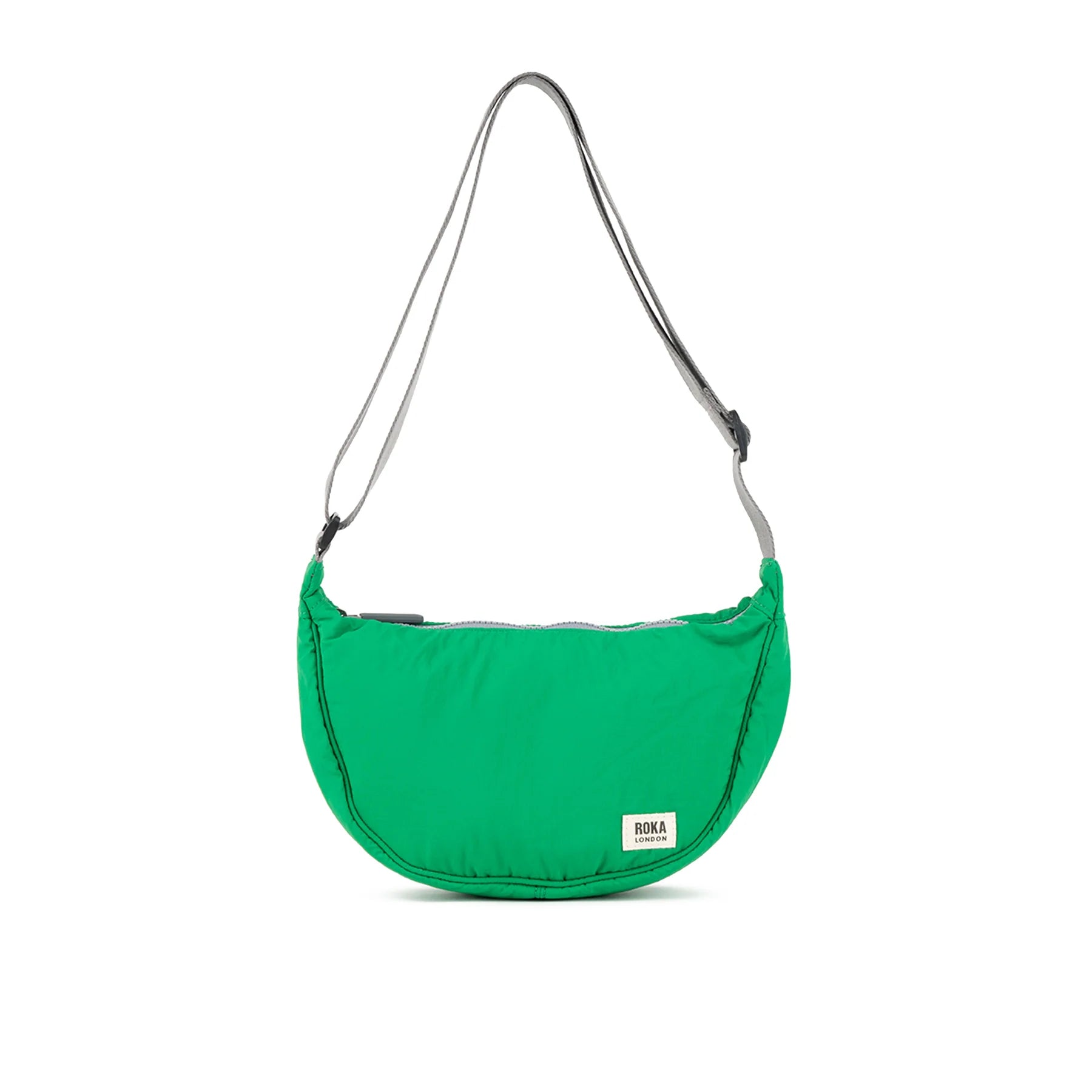 Bright green crescent-shaped crossbody bag with gray straps and a small "ROKA LONDON" label.