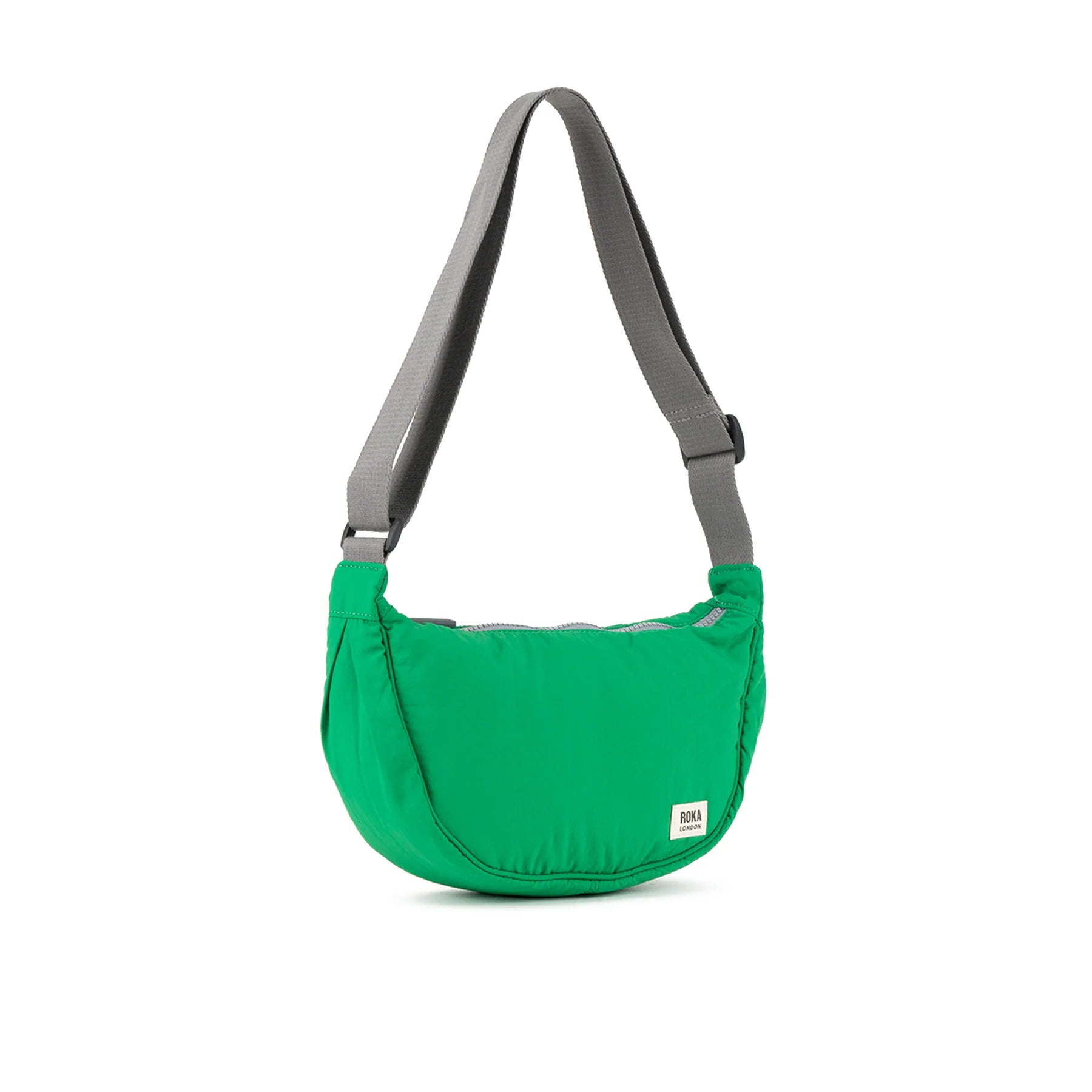Bright green crescent-shaped crossbody bag with gray shoulder strap. The bag has a subtle sheen and a small brand label.