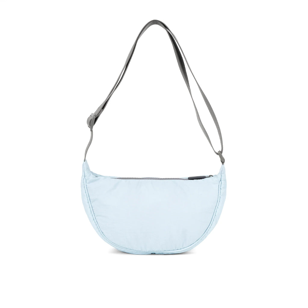 Light blue ROKA bag with a curved shape and a grey strap, designed for casual use.