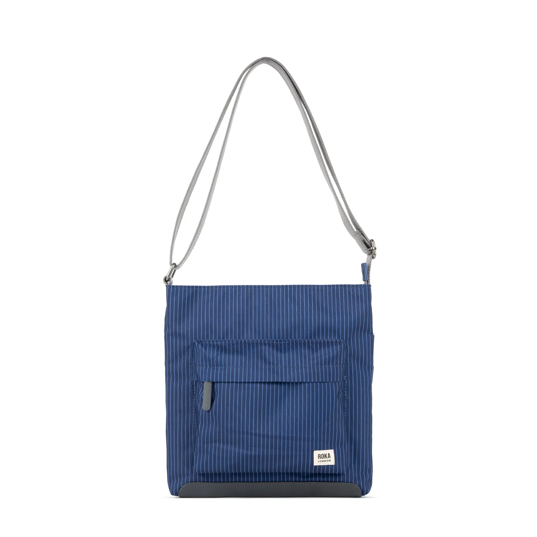 Navy blue pinstripe crossbody bag with gray shoulder strap and bottom panel. Features a small front zippered pocket.