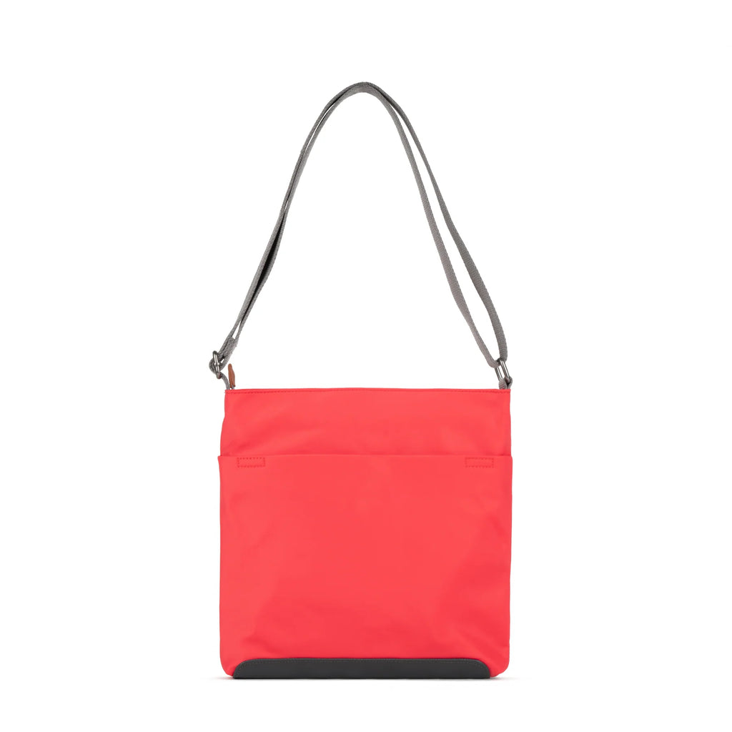ROKA red crossbody bag with a sleek design and adjustable strap, perfect for everyday use.