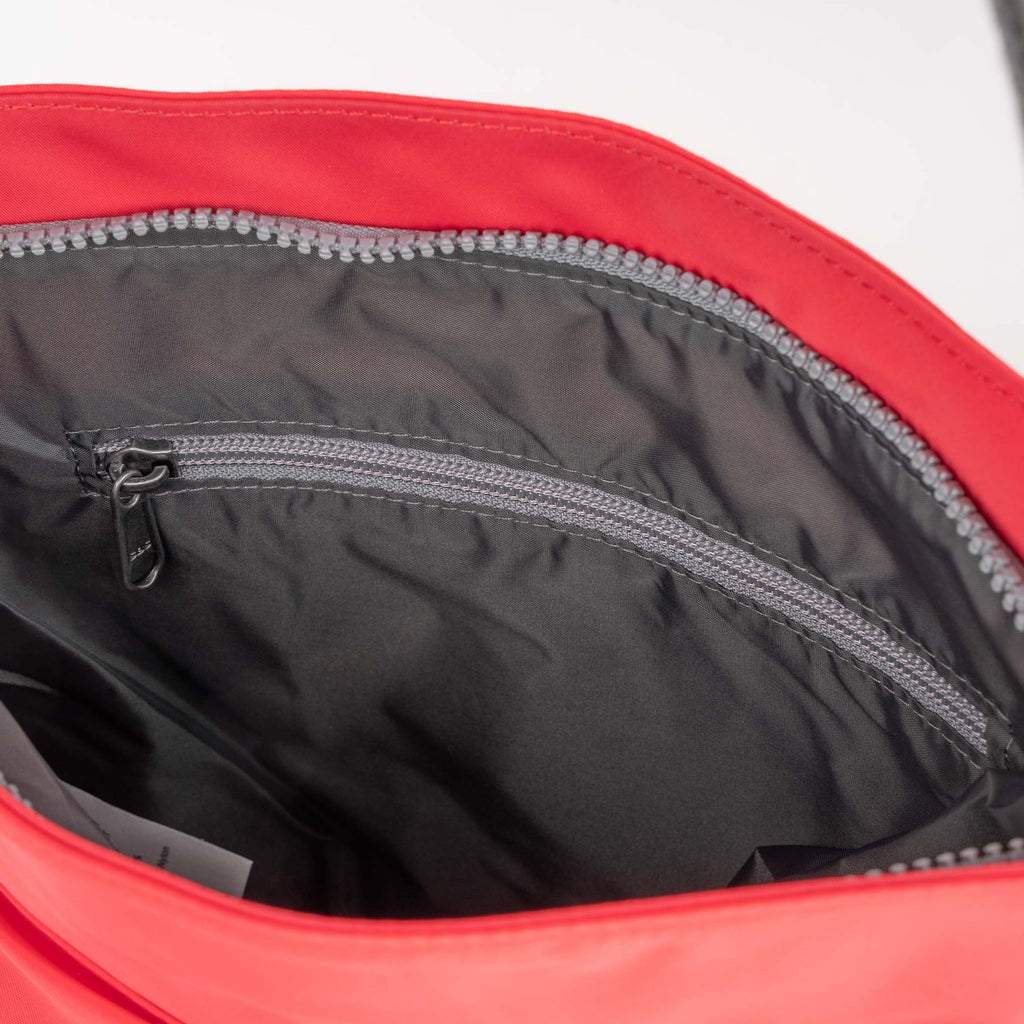 Interior view of a ROKA bag, featuring a sleek black lining and a zippered pocket for secure storage.