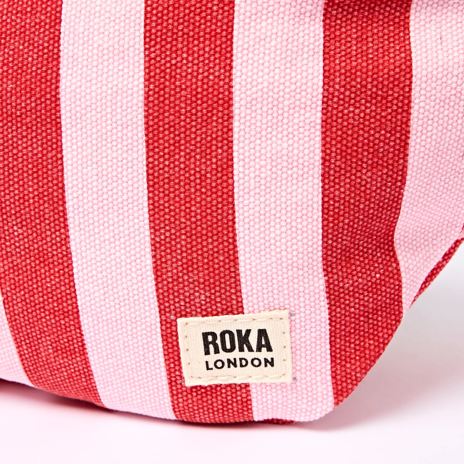 Red and white striped bag with Roka London label on a white background
