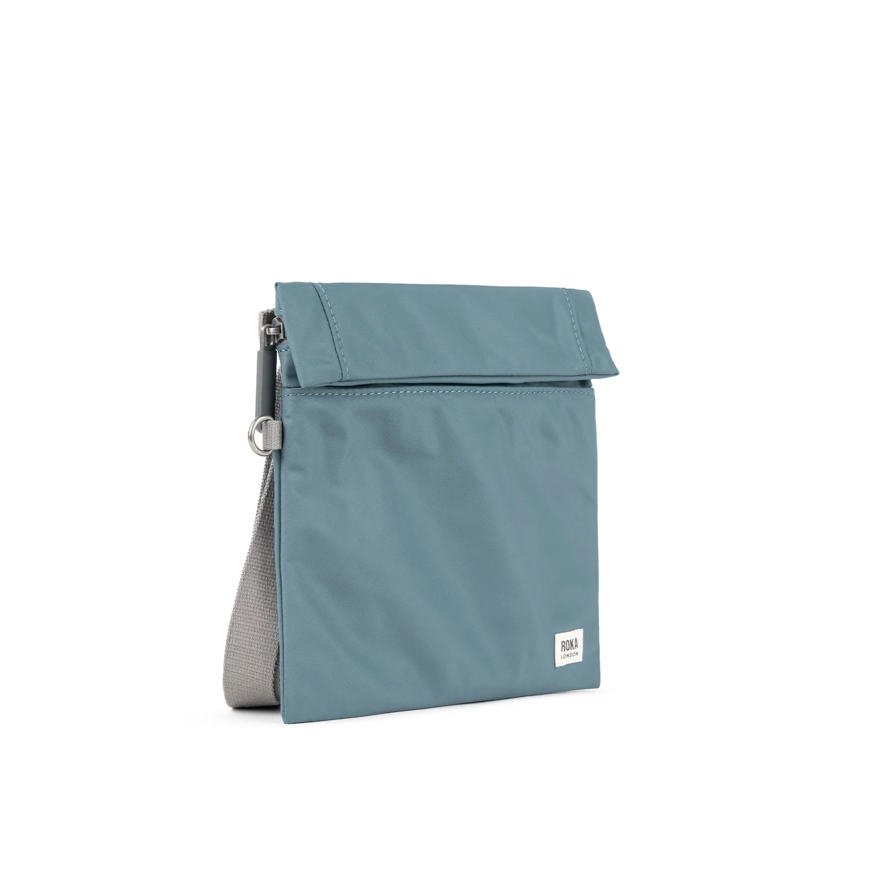 A stylish teal ROKA bag with a roll-top design and a side pocket, perfect for everyday use.