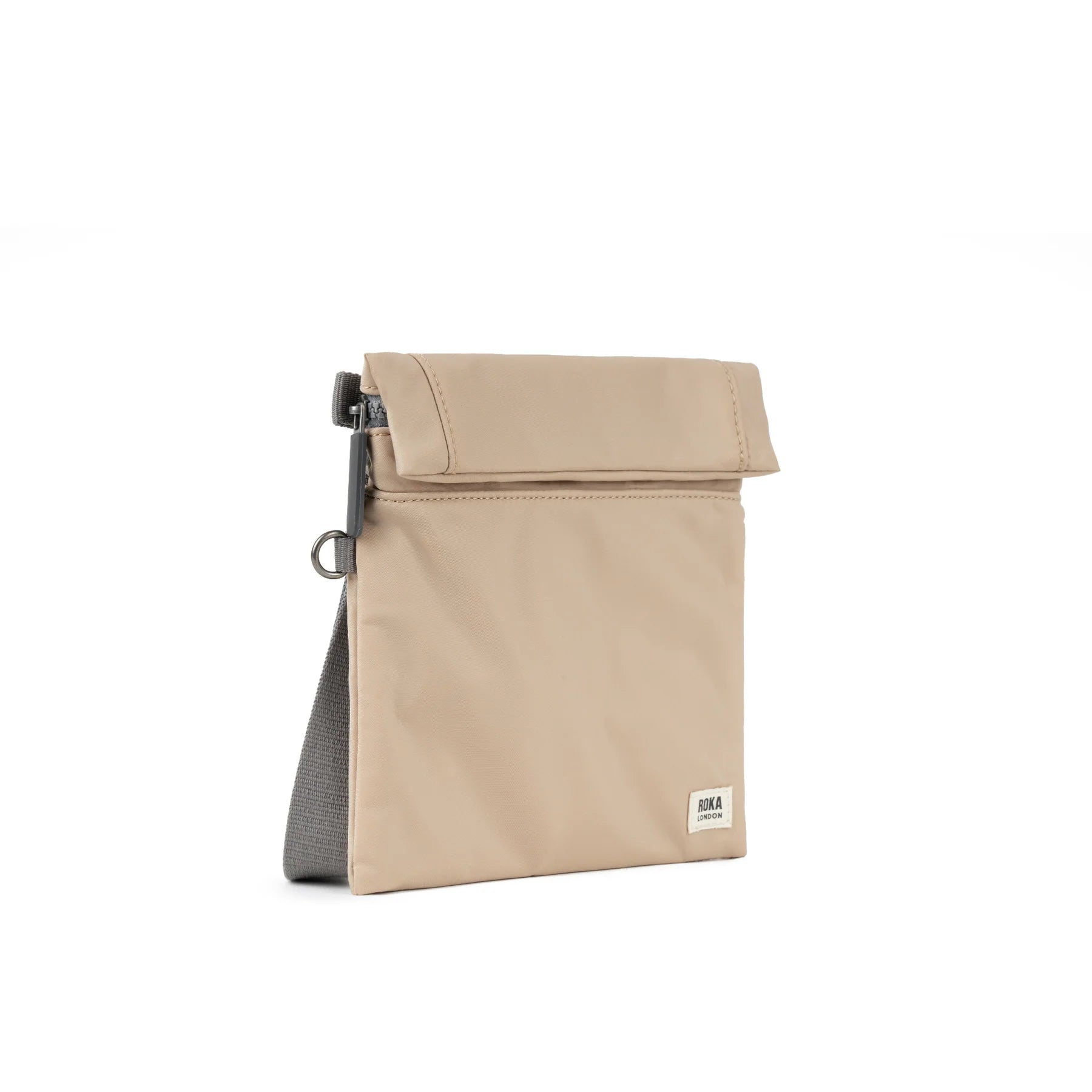 Beige ROKA bag with a roll-top design and a gray base, featuring a zipper and logo tag.
