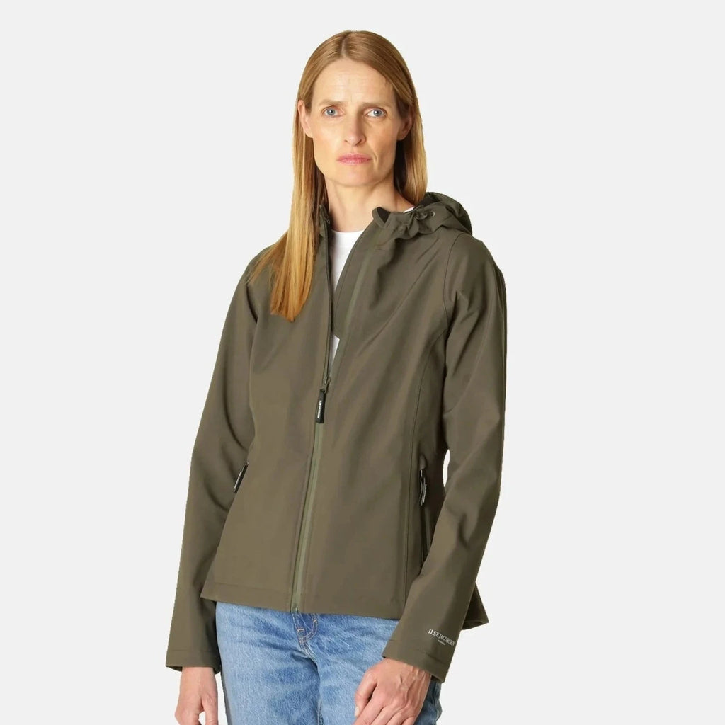 Woman in olive green Ilse Jacobsen hooded soft shell jacket, light blue jeans. The jacket has a zip front and subtle branding.