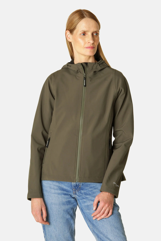 Woman wearing olive green Ilse Jacobsen Softshell hooded jacket, light blue jeans. Smooth, matte jacket fabric.
