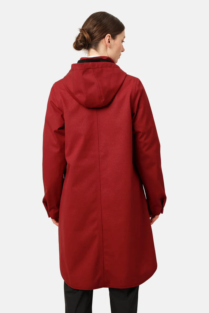 Rear view of a woman wearing a burgundy hooded raincoat with a subtle textured surface. The coat is knee-length and features a