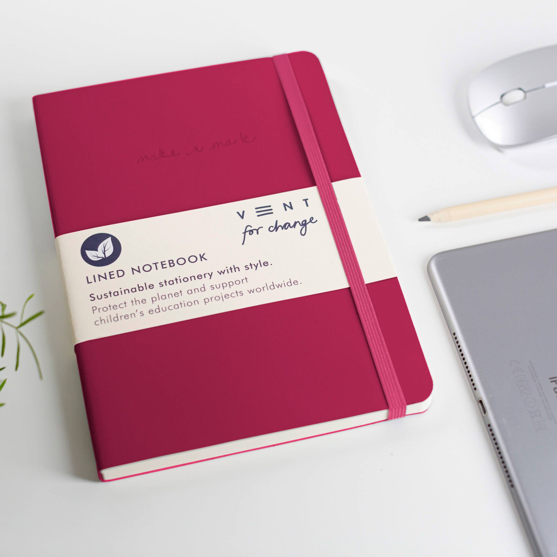 Crimson lined notebook with elastic closure; "Vent for change" and sustainability details printed on cover.