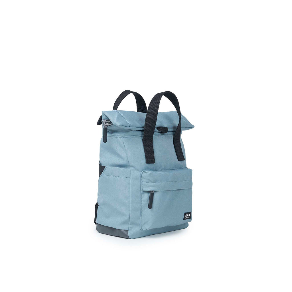 Blue ROKA bag with a roll-top design and adjustable straps, featuring multiple pockets for storage.