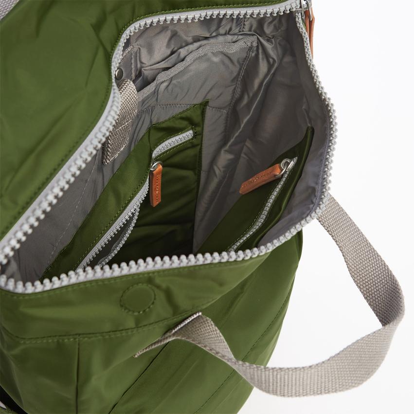 Olive green nylon tote bag with light gray zipper accents and multiple interior pockets.