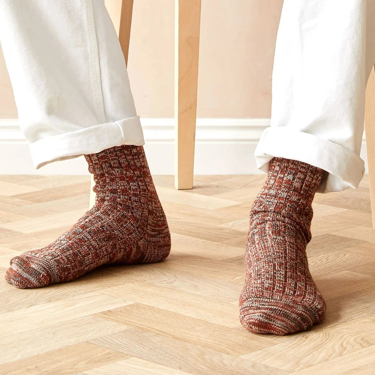 Pair of rust-colored wool socks with a textured knit pattern.