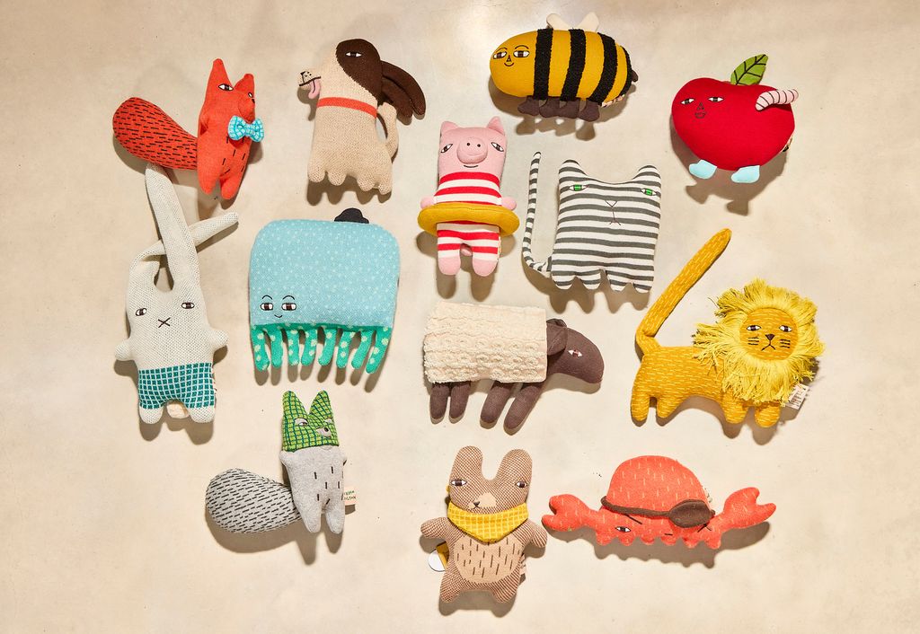 Collection of colorful animal-themed combs on a beige background