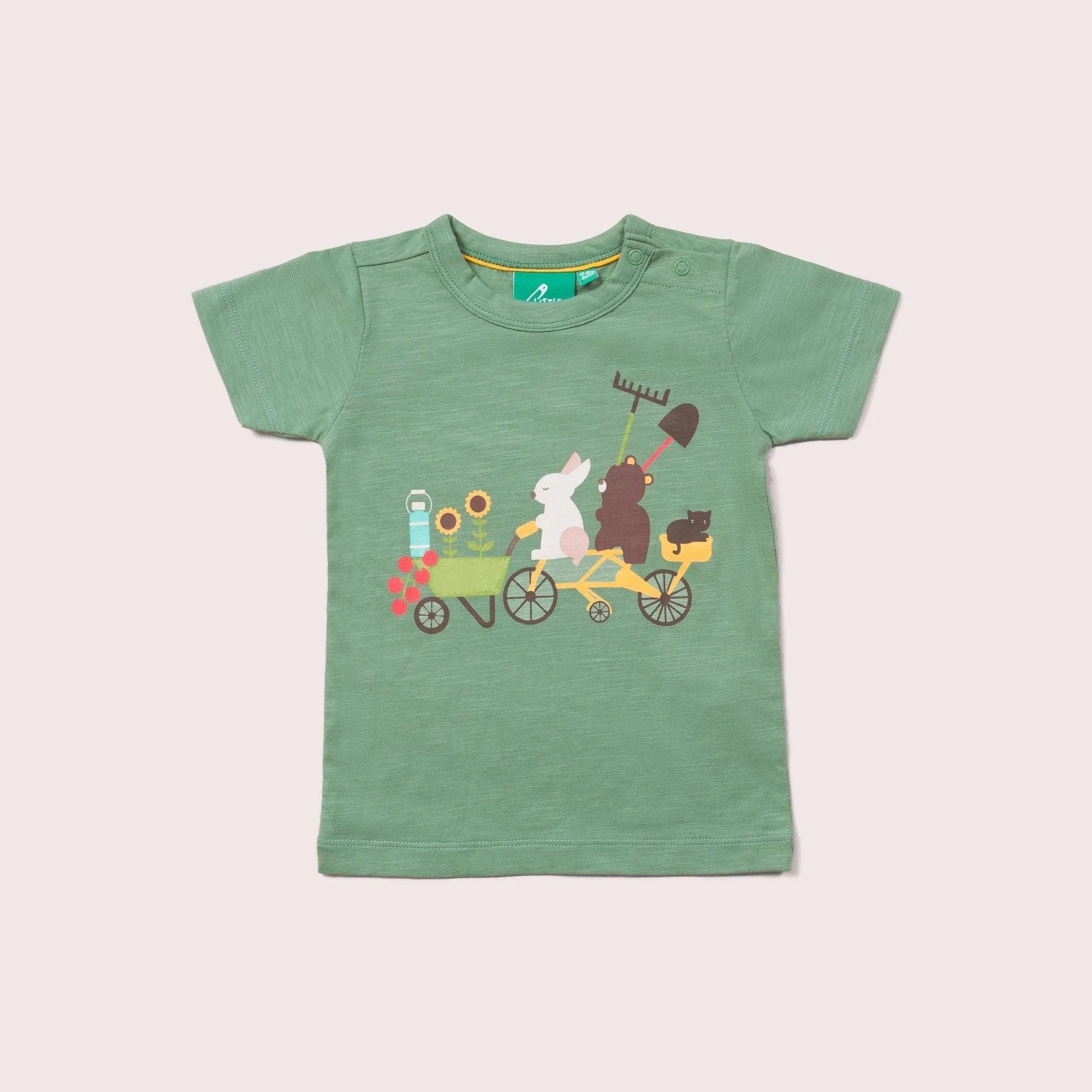 Sage green baby t-shirt featuring a whimsical illustration of animals—a rabbit, bear, and cat—riding a bicycle with