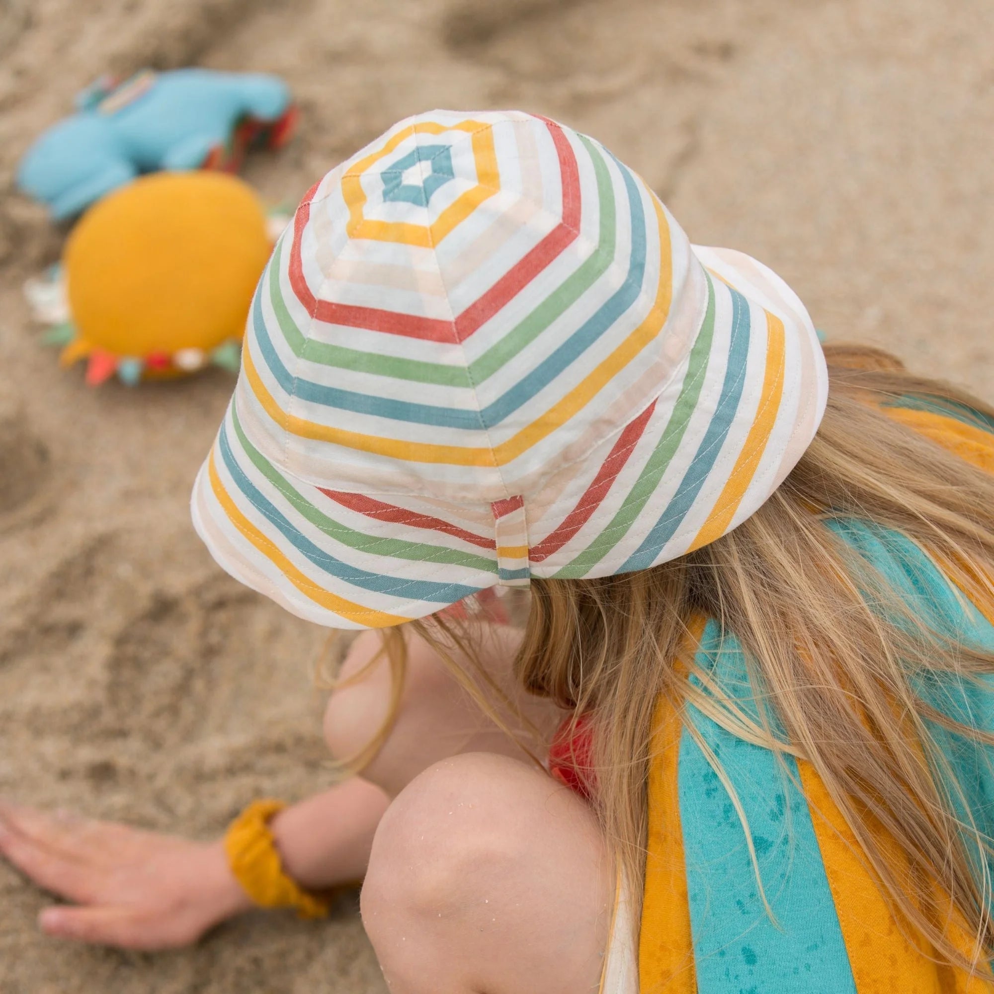 Child's multicolored striped bucket hat with a wide brim.