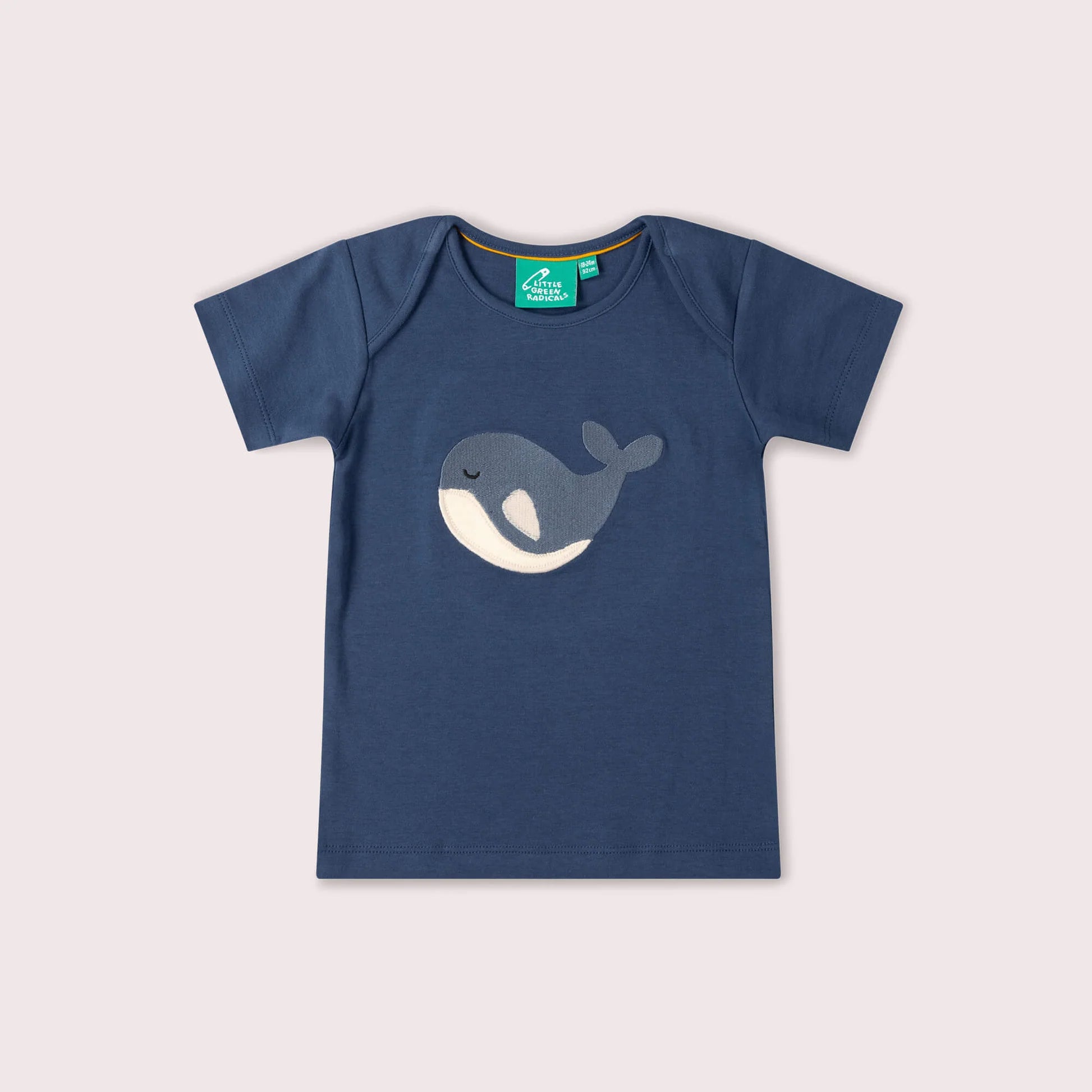 Blue t-shirt with whale design on a light gray background
