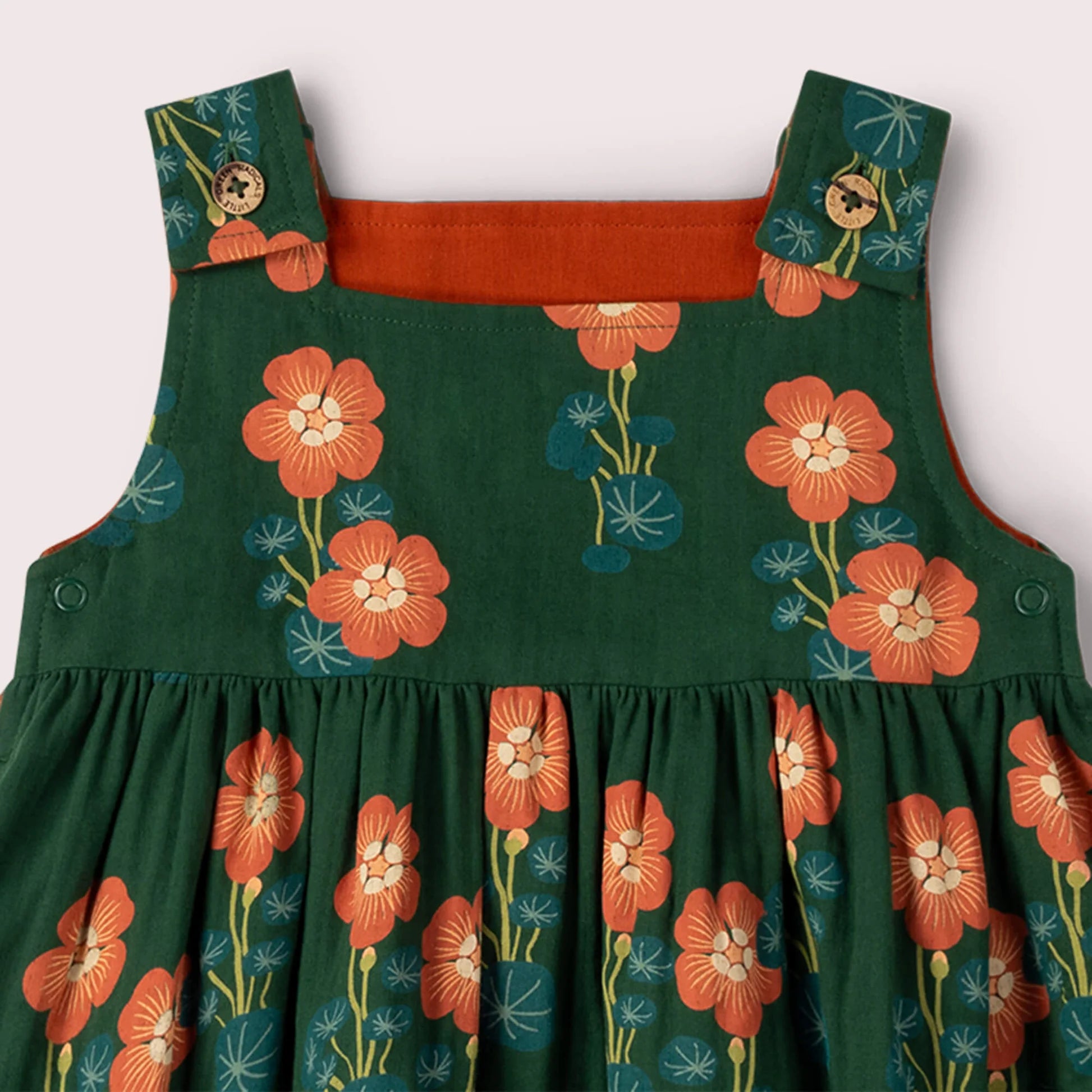 Green dress with orange floral patterns on a white background