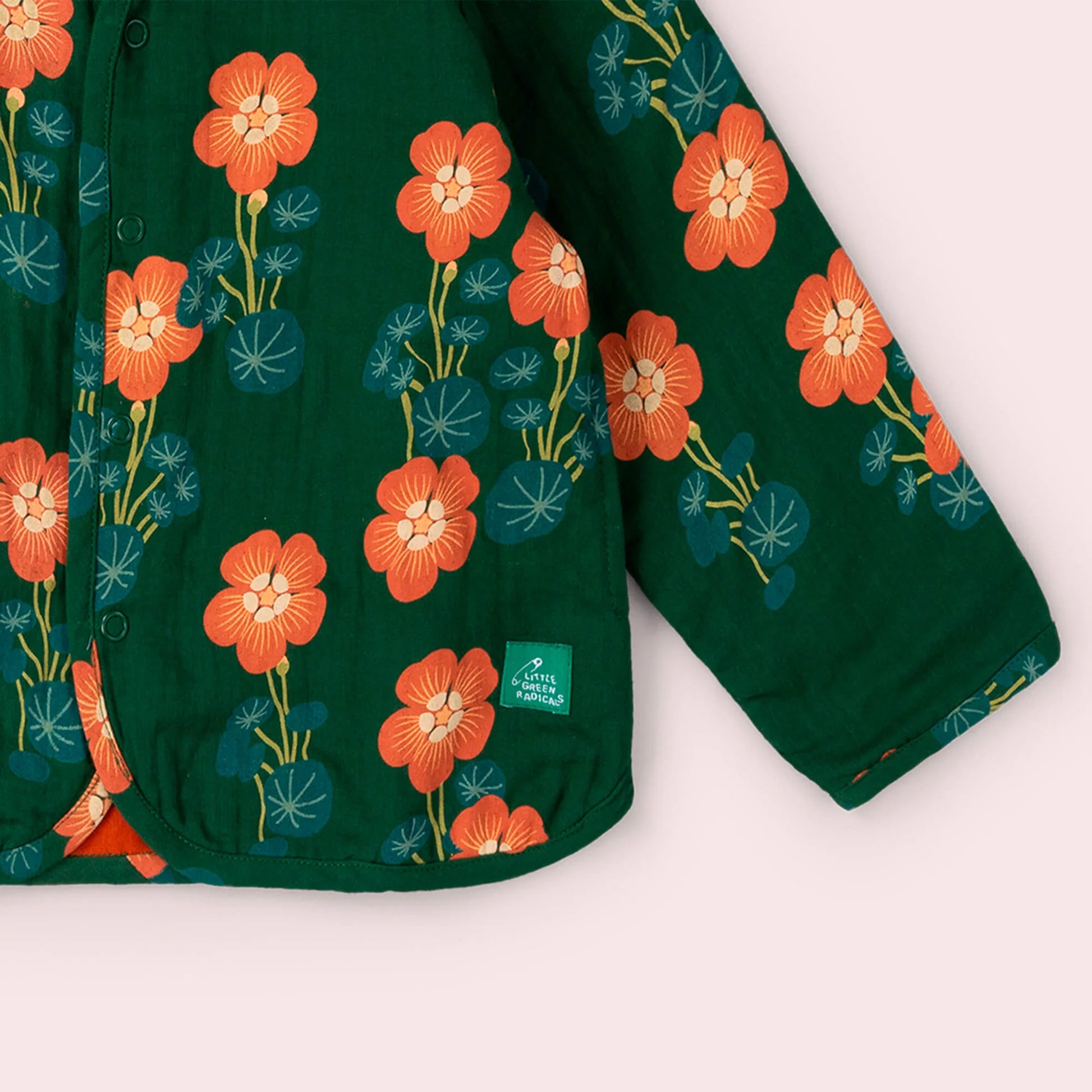 Green garment with orange floral pattern on a white background