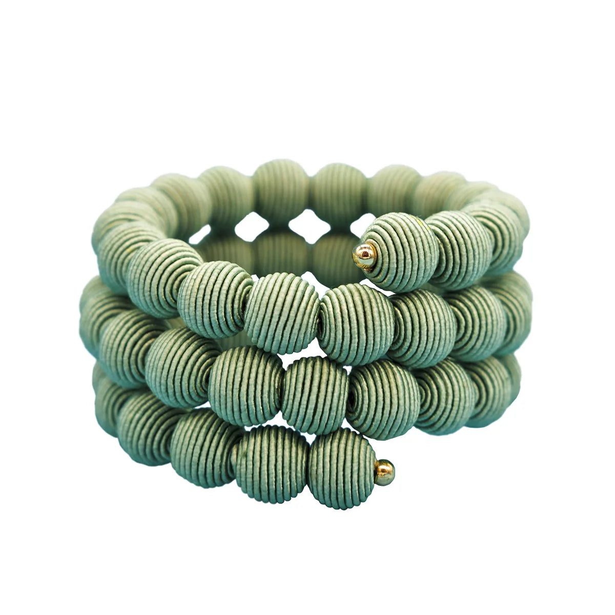 Triple-wrap bracelet of pale green, ribbed beads with gold accents.
