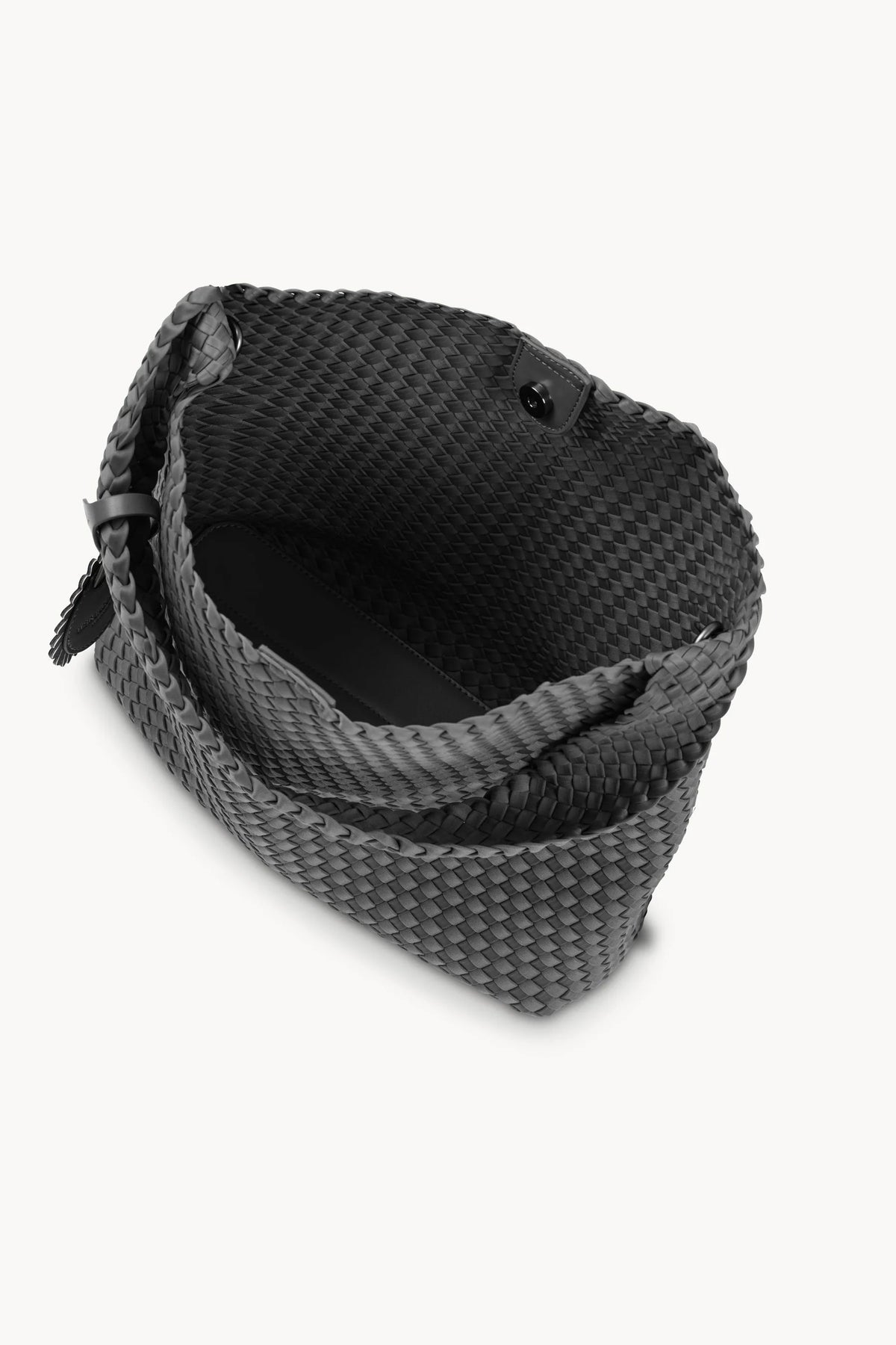 A black woven leather clutch bag shown from an overhead angle on a light gray background.