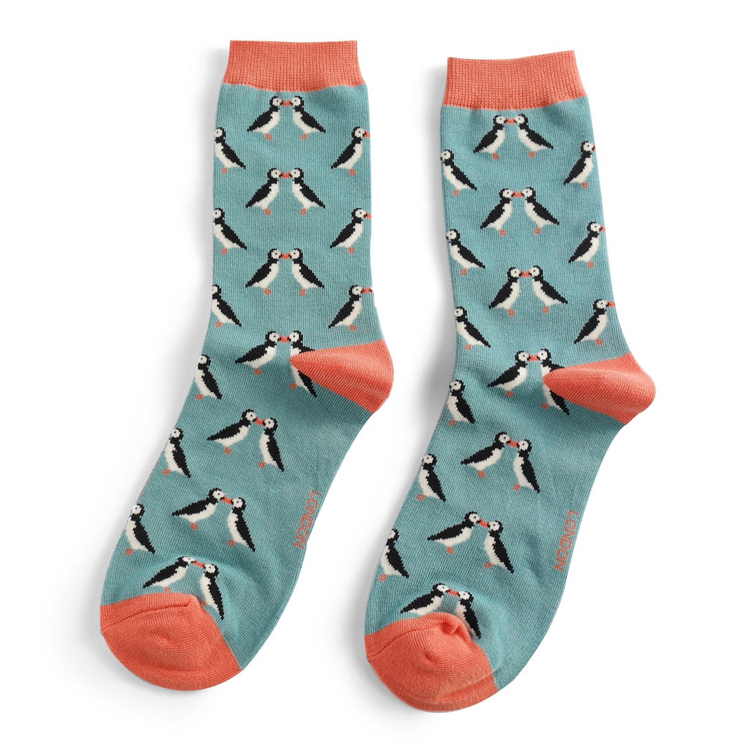 Pair of teal socks with a repeating pattern of kissing puffins.  Coral-colored cuffs.