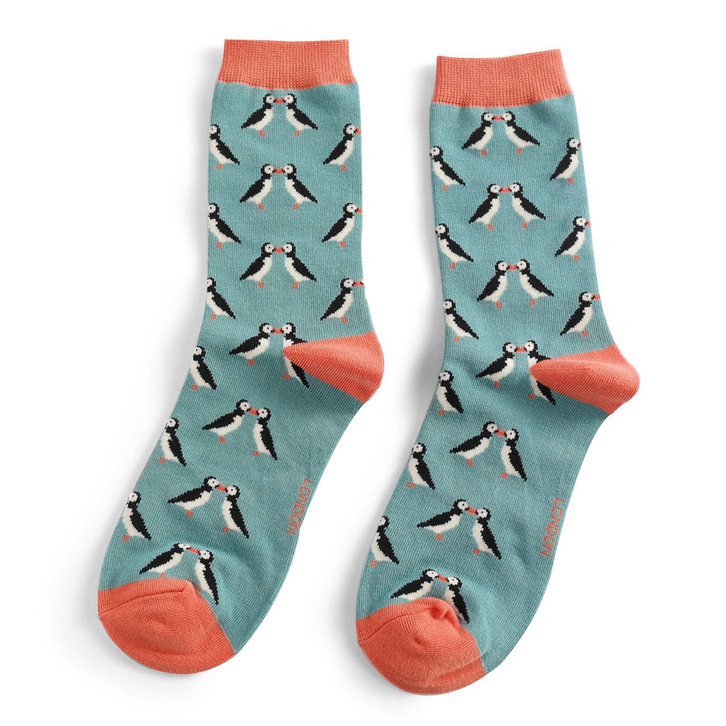 Pair of teal socks with a repeating pattern of kissing puffins.  Coral-colored cuffs.
