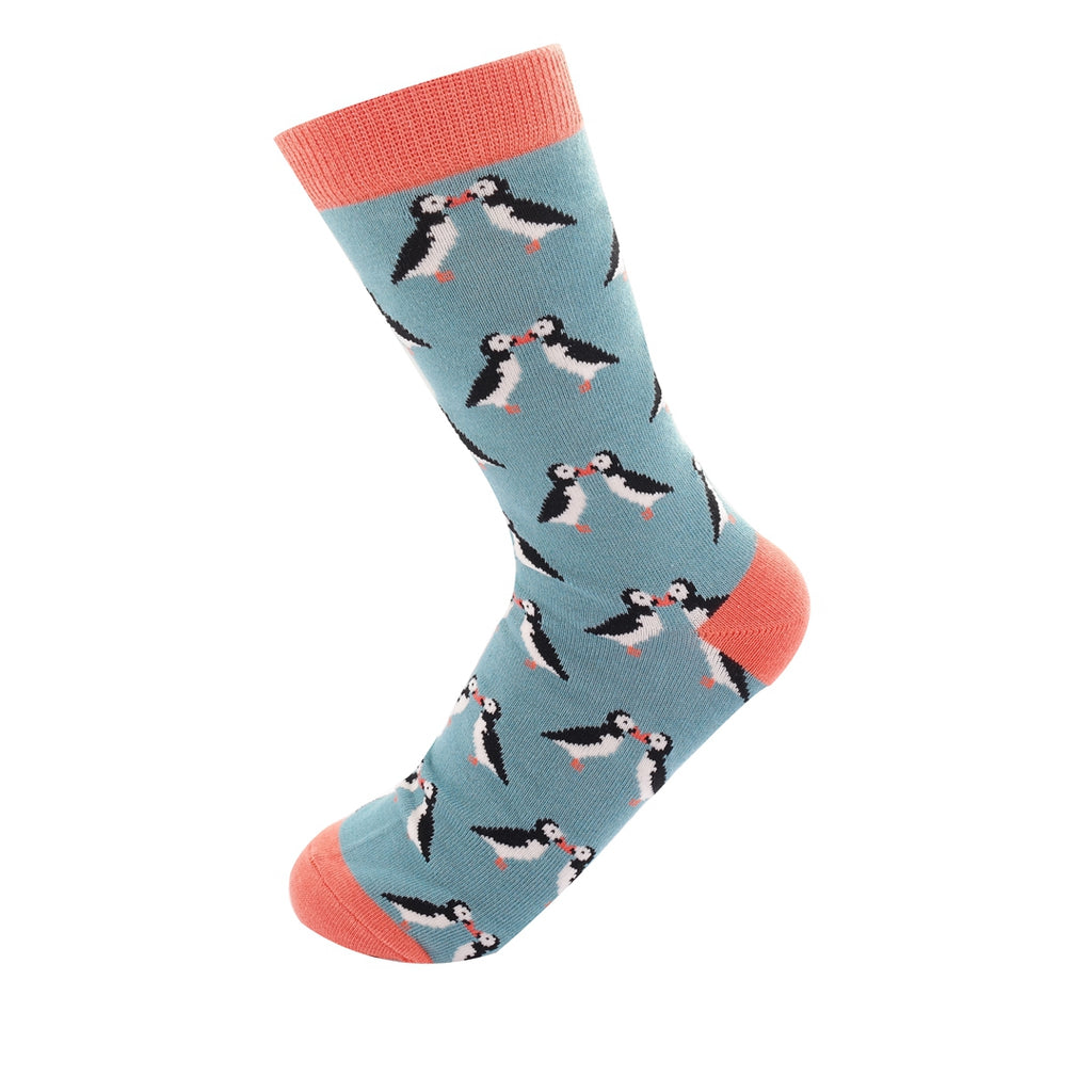 Single teal sock with coral cuff, featuring a repeating pattern of kissing puffins.