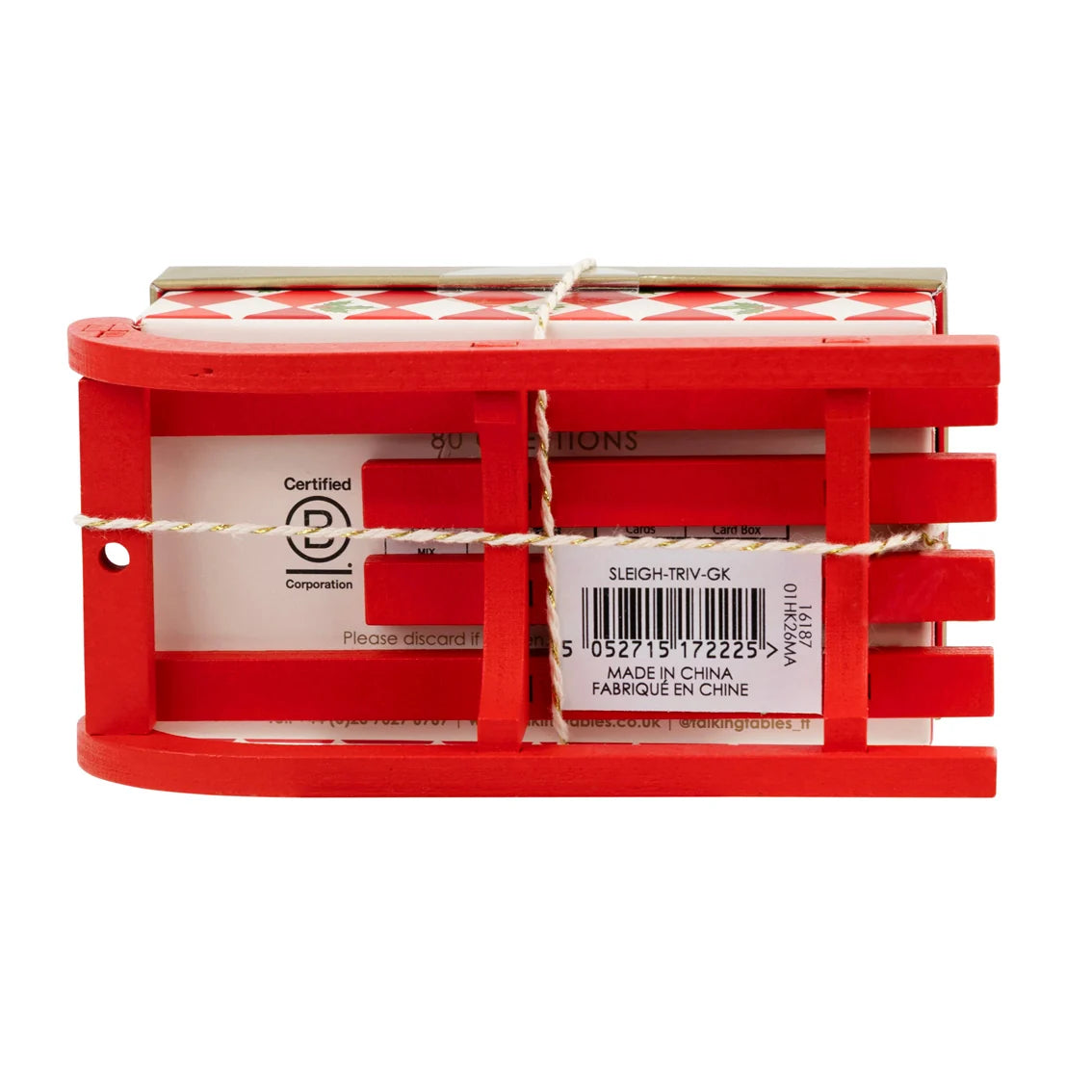 Red plastic toy sleigh with a white label on a white background