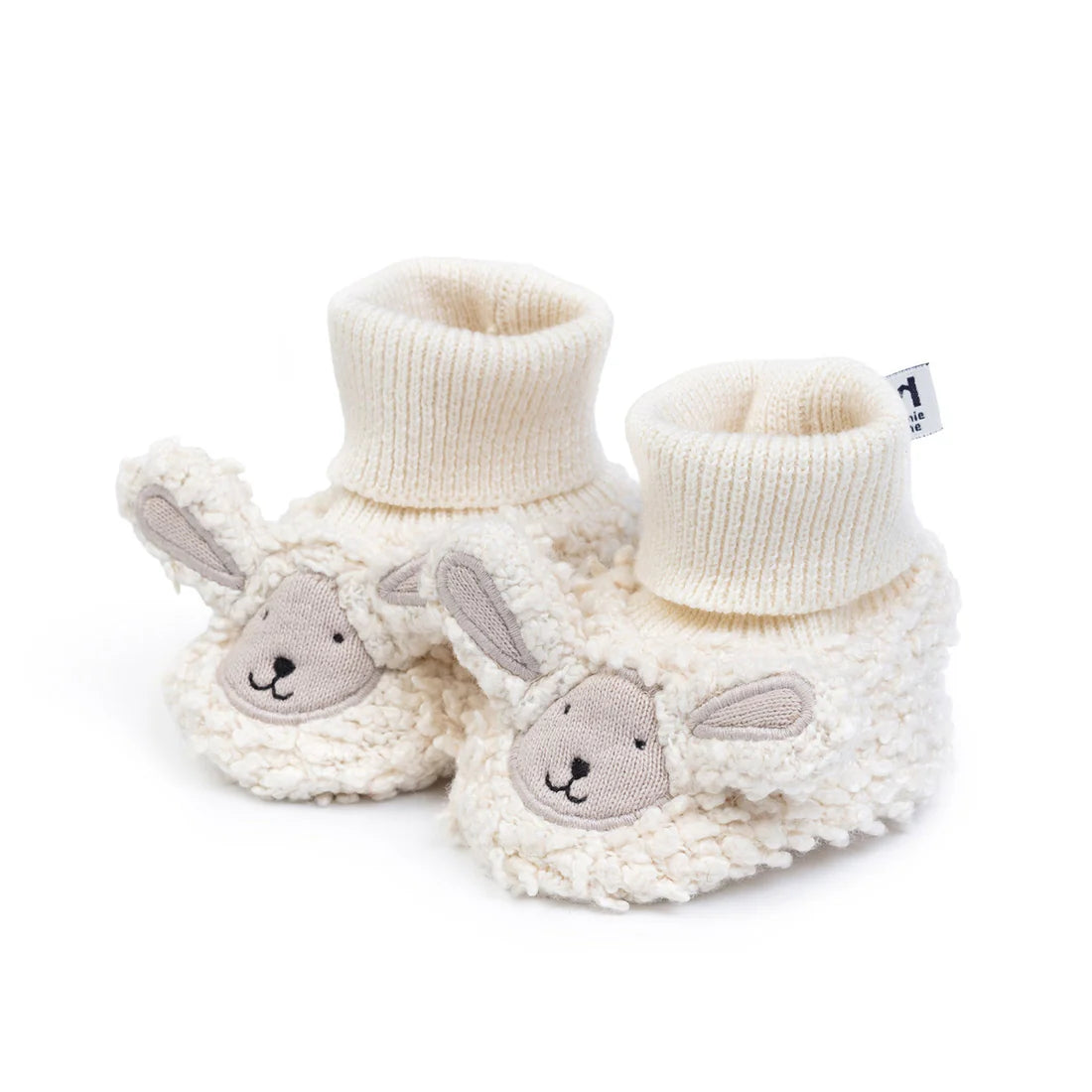 Pair of white baby booties with bunny faces on a white background