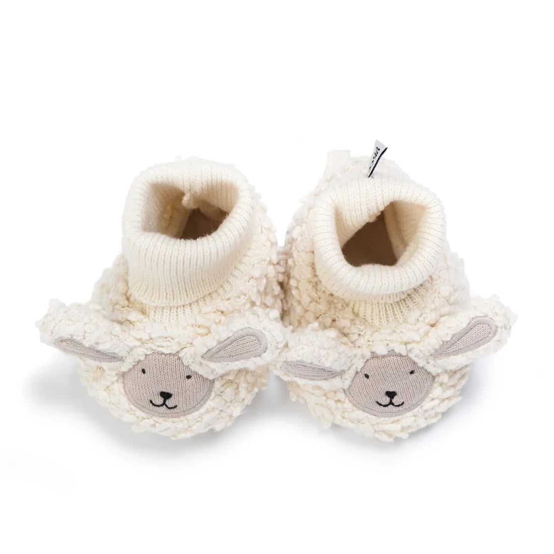 Pair of cream-colored baby booties with bunny face designs on a white background